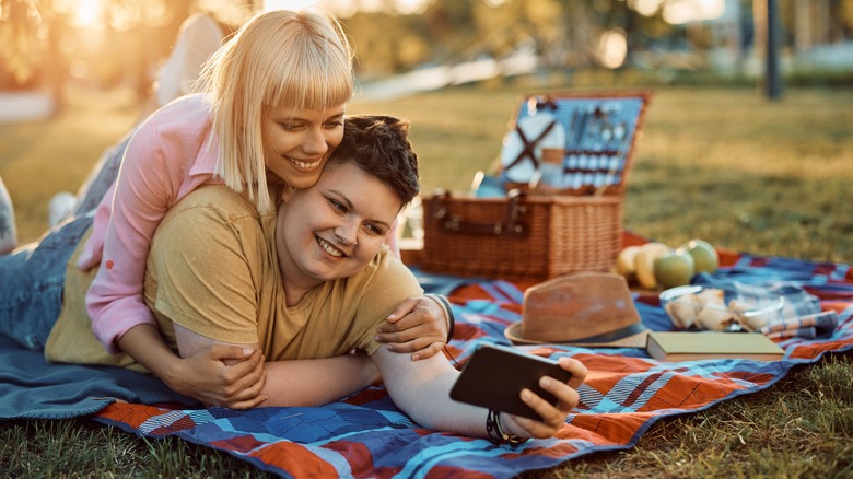 girlfriends taking selfie on picnic date