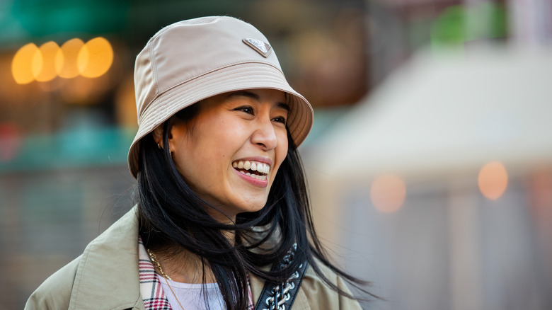 woman wearing prada bucket hat