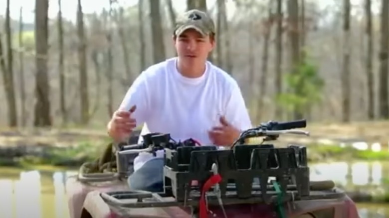 Shain Gandee riding a vehicle on Buckwild