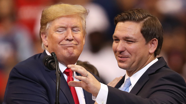 Donald Trump looking smug next to Ron DeSantis