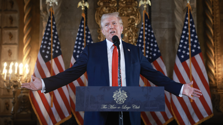 Donald Trump with his arms outstretched at Mar-a-Lago