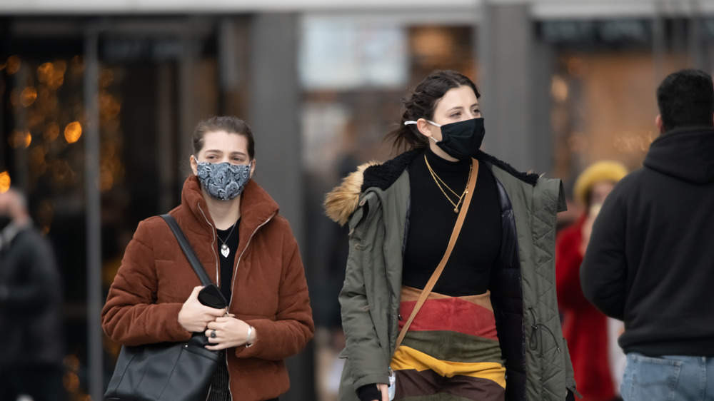 Two women wearing masks