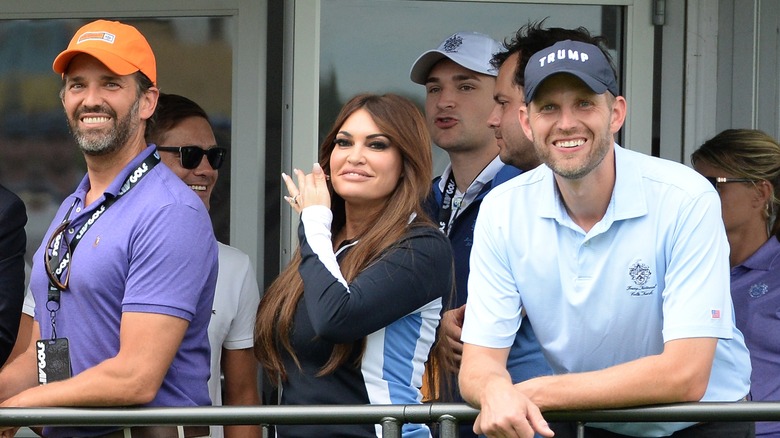 Donald Trump Jr.,Kimberly Guilfoyle and Eric Trump at the 16th Hole during LIV Golf Tournament