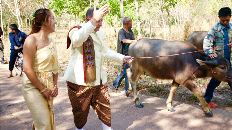 David Toborowsky and Annie Suwan with livestock in Thailand