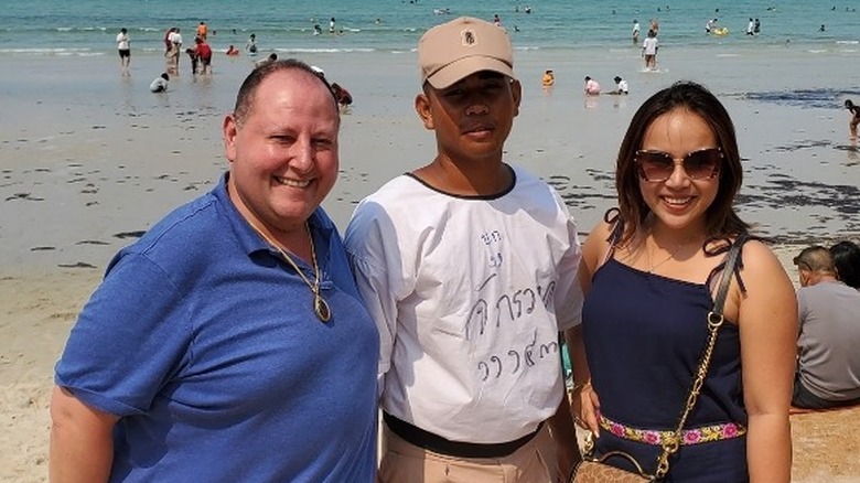 David Toborowsky and Annie Suwan with a friend on a beach