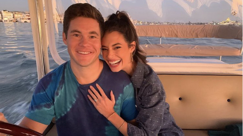 Adam DeVine and Chloe Bridgers on a boat