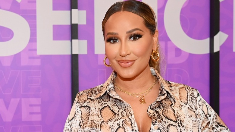 Adrienne Bailon posing at Essence Beauty Carnival