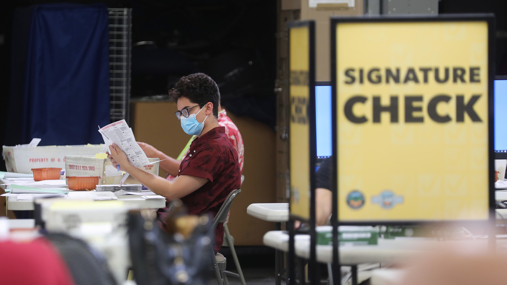 A man checking ballots in a polling station