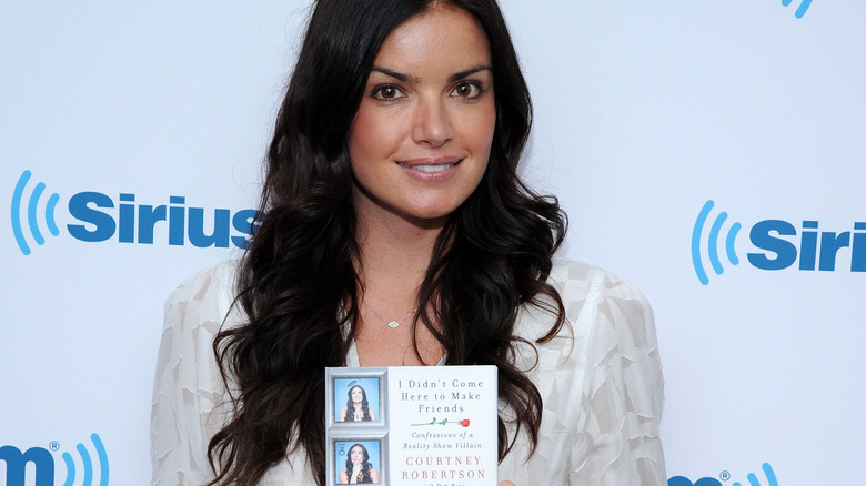 Courtney Robertson holding her book