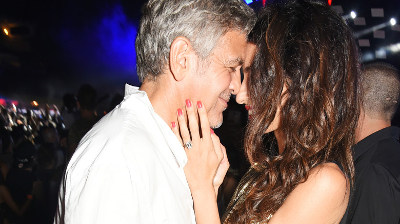 George Clooney and Amal Clooney touching noses