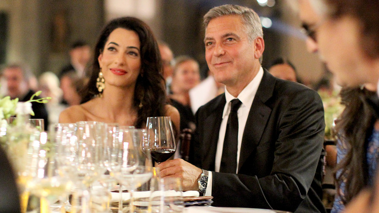 Amal and George Clooney looking off into the distance