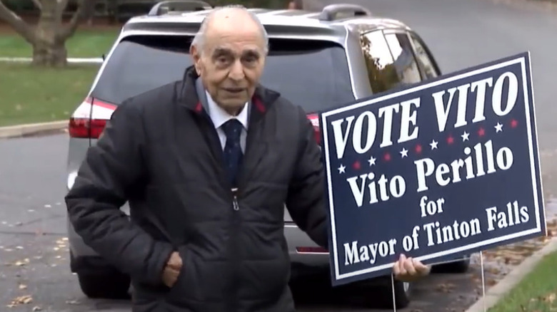 Vito Perillo holding up a campaign sign