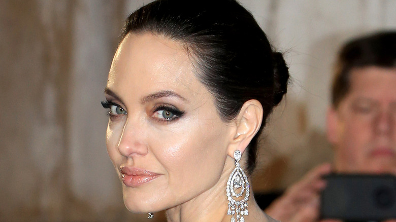 Angelina Jolie looks over her shoulder