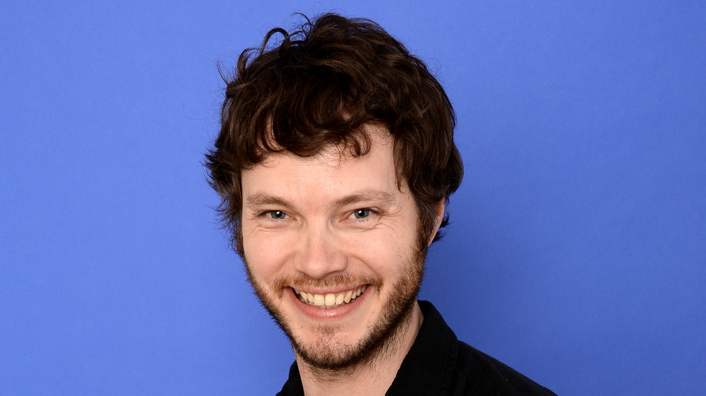 Ben Richardson in front of a blue background