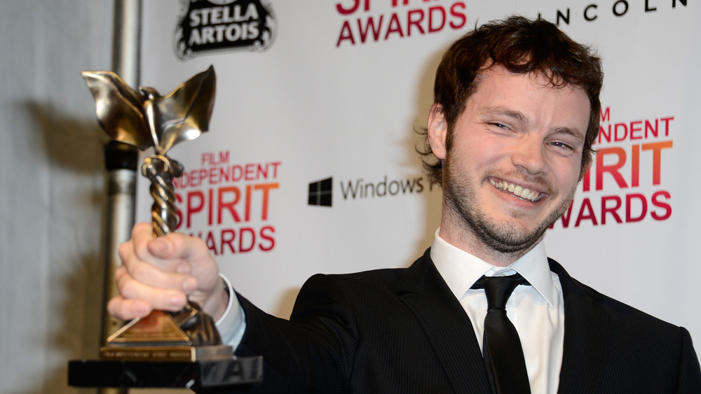 Ben Richardson holding an award trophy