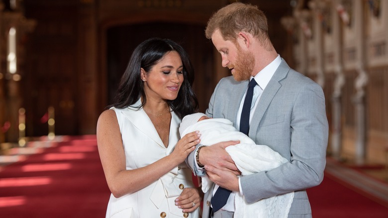 Meghan and Harry peering down at baby Archie