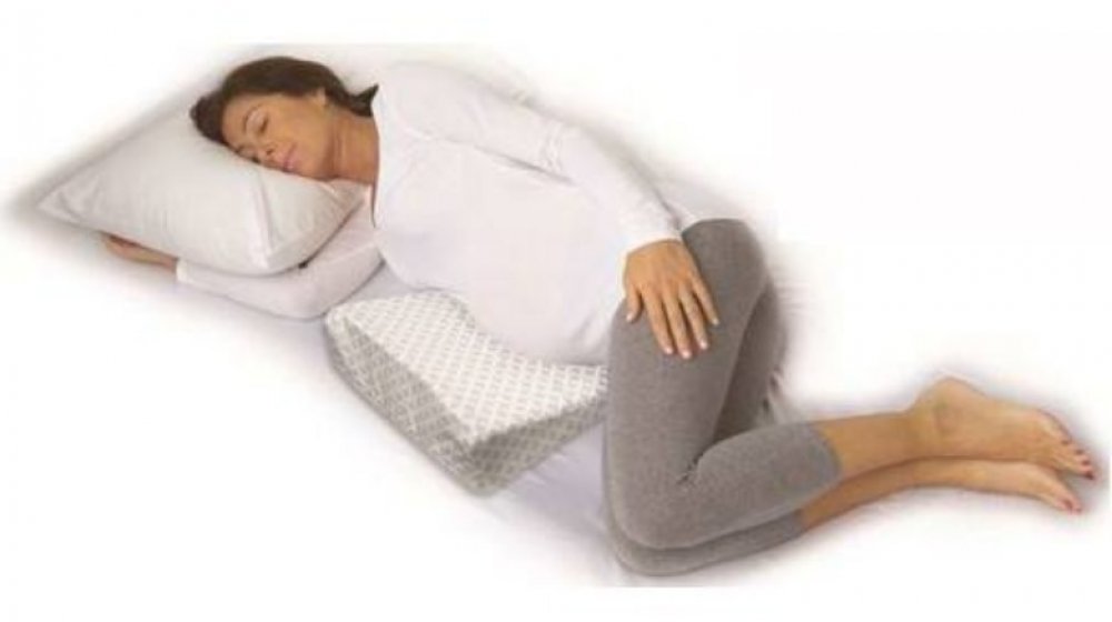 Pregnant woman using wedge pillow