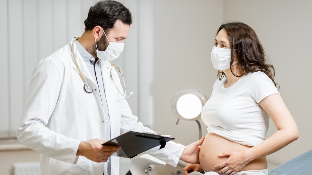 pregnant woman at doctor during a pandemic