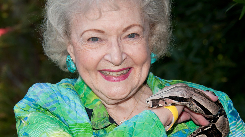 Betty White smiling with a snake