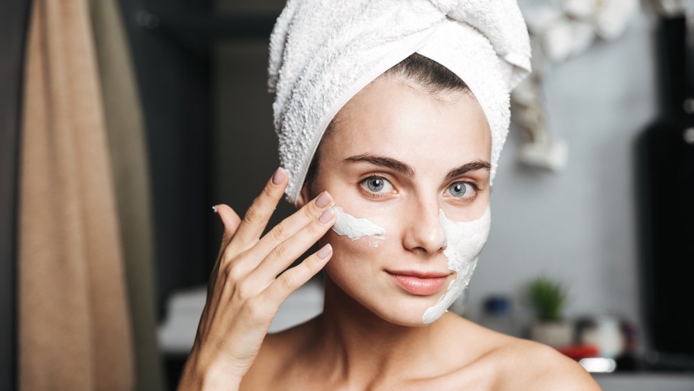 woman applying face mask to get rid of blackheads