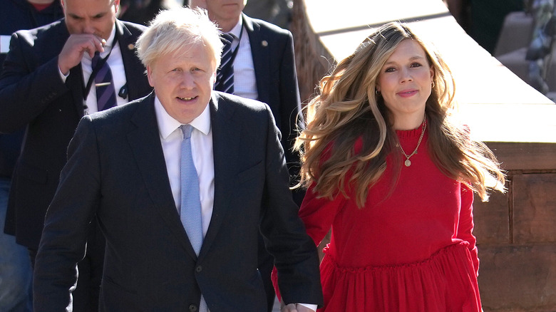 Boris, Carrie Johnson holding hands, smiling