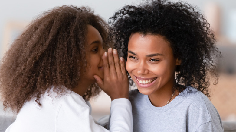 Two women sharing a secret