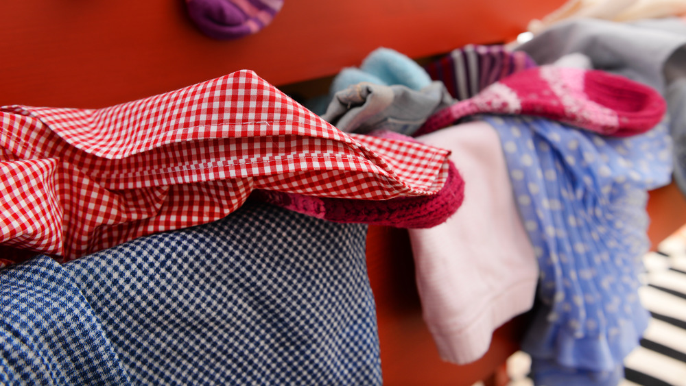 pile of clothes in an open drawer