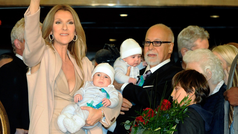 Celine Dion smiling with husband and three children 