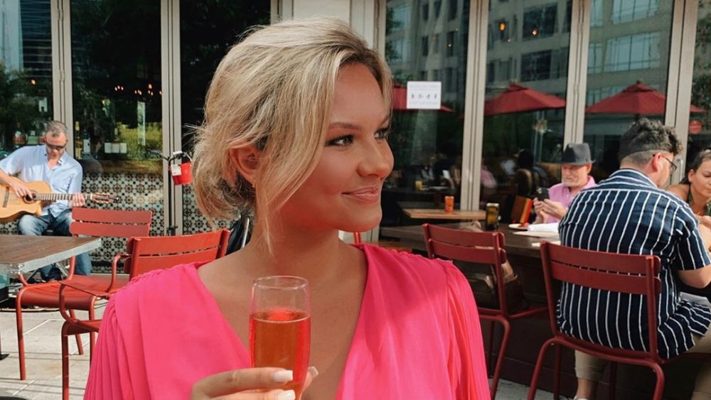 Chase Chrisley's girlfriend Emmy Medders wearing pink and having a drink