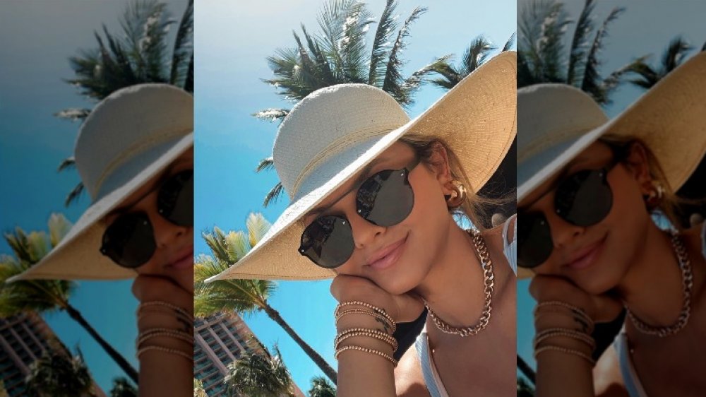 Chase Chrisley's girlfriend Emmy Medders wearing a hat and sunglasses