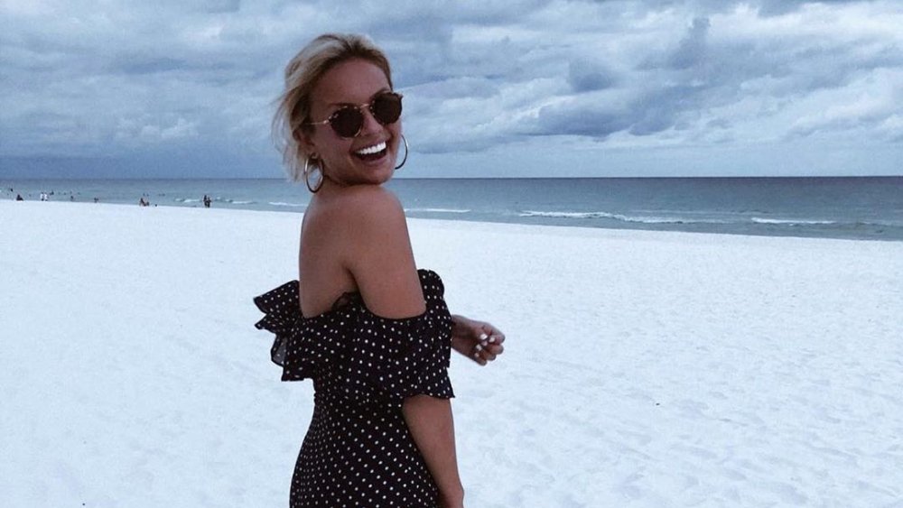 Chase Chrisley's girlfriend Emmy Medders smiling on a beach