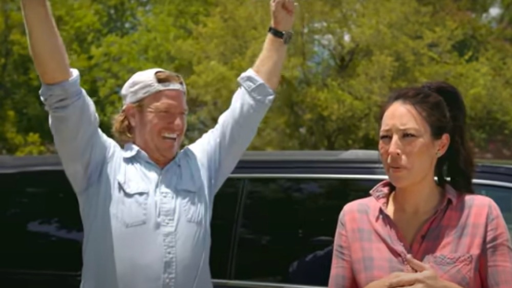 Chip and Joanna Gaines in front of trees