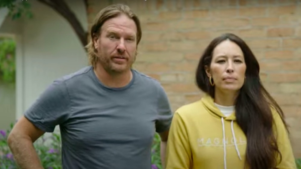 Chip and Joanna Gaines in front of a brick wall