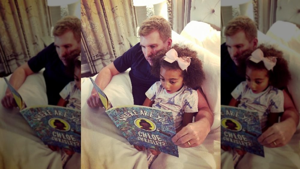 Todd and Chloe Chrisley reading a book