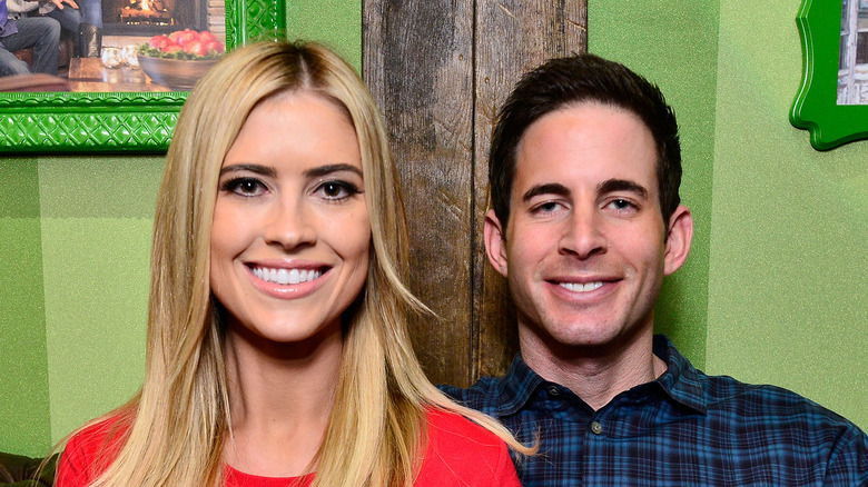 Christina Haack and Tarek El Moussa in front of a green background 
