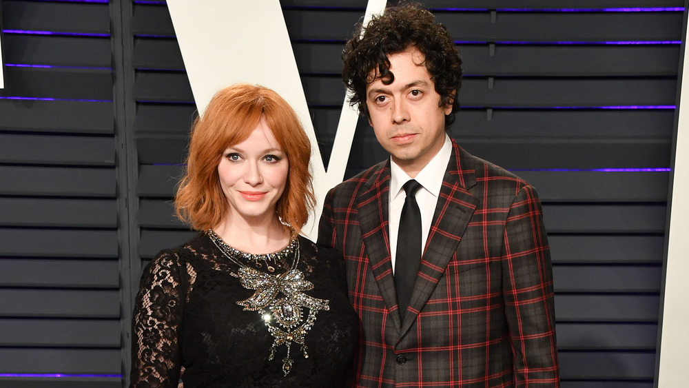 Christina Hendricks, Geoffrey Arend posing at event