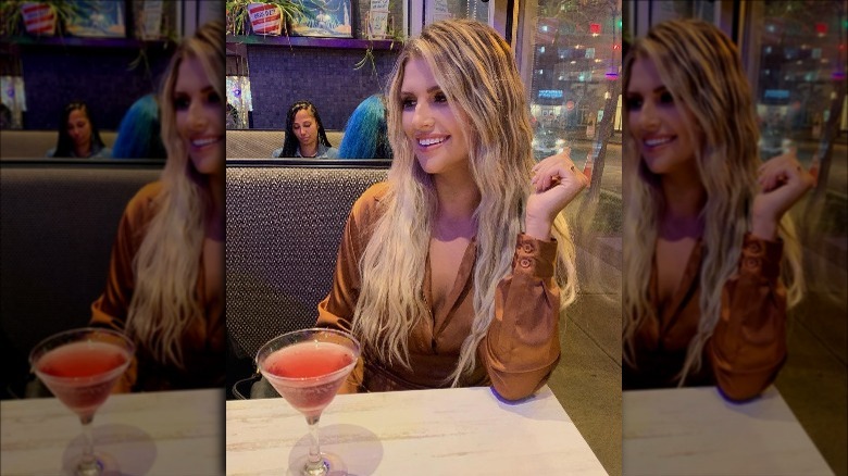 The Bachelor's Claire Heilig poses with a cocktail