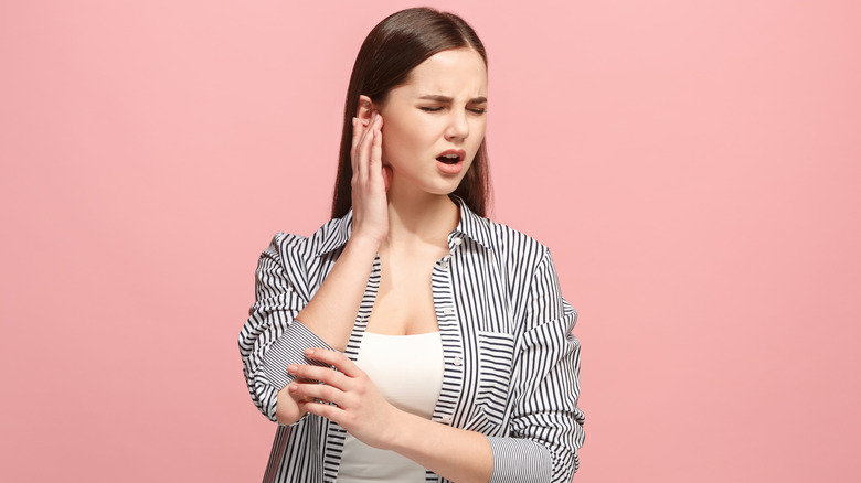 Woman experiencing ear pain