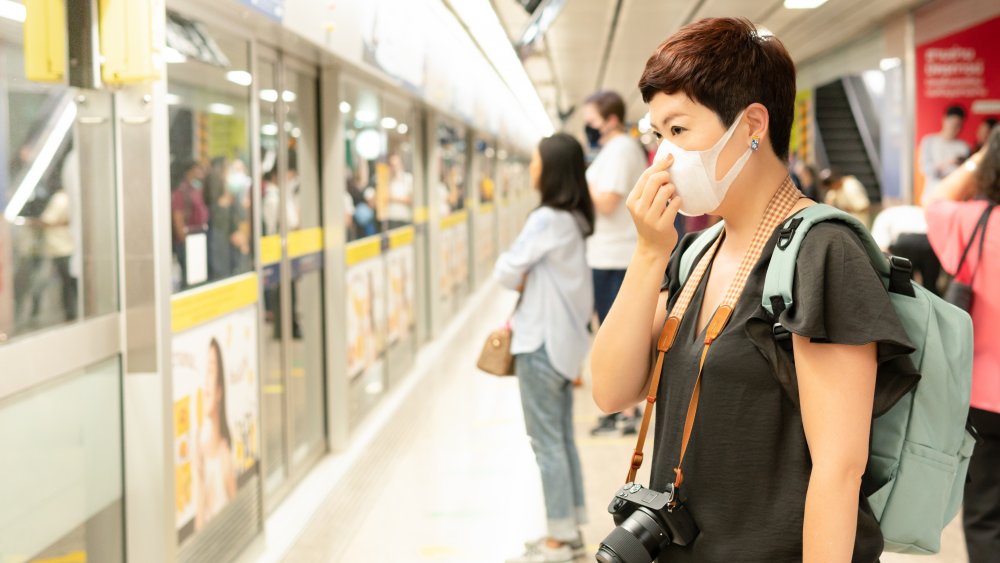 People practicing social distancing on a train platform