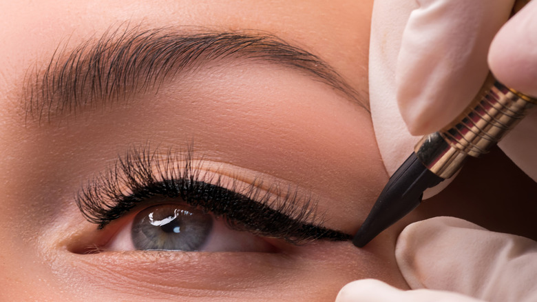 Woman getting permanent eyeliner