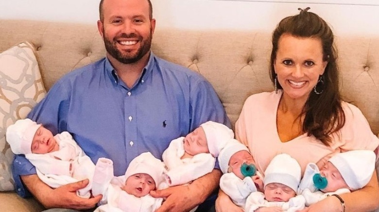 Eric and Courtney Waldrop smiling with their sextuplets