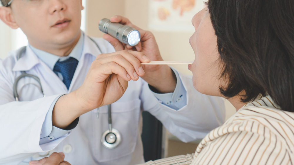 Doctor looking at patient's tongue