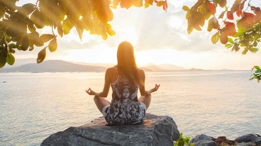 Woman doing sunrise yoga