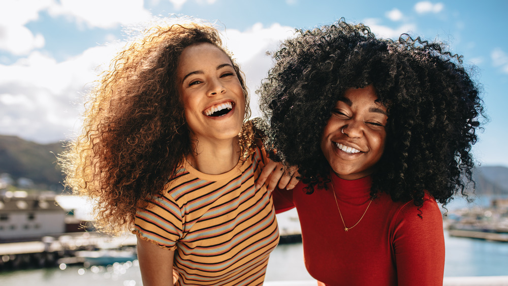 Two woman with large, curly manes