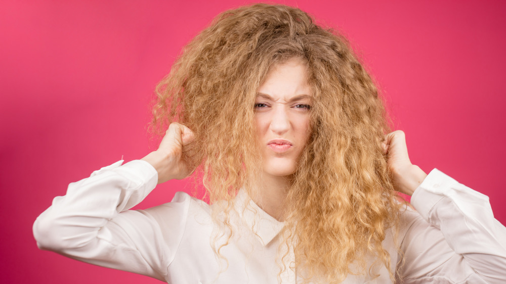 A woman with frizzy, curly hair