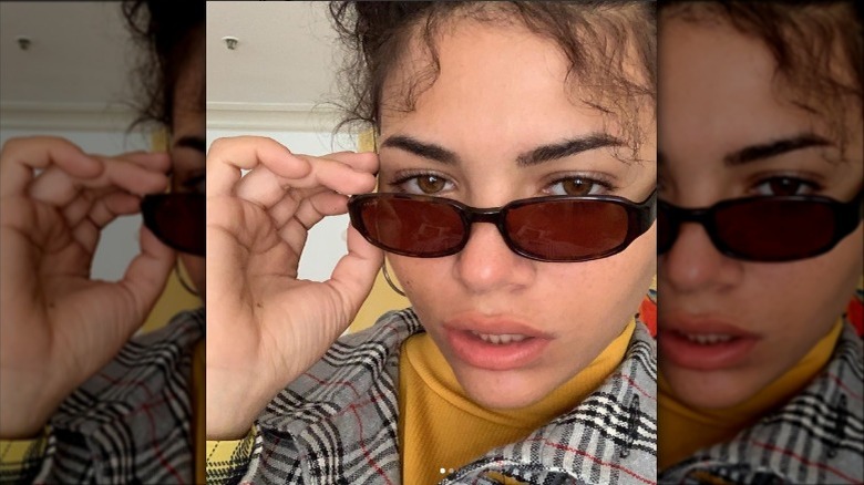 Alexandria lowering her sunglasses in a selfie