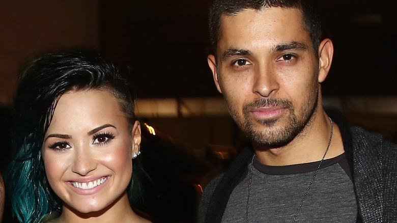 Wilmer Valderrama and Demi Lovato pose together at an event