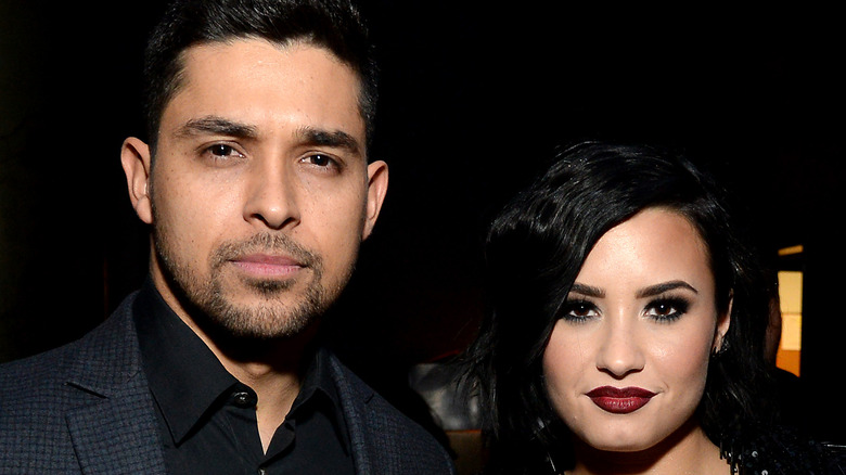 Wilmer Valderrama and Demi Lovato pose together at an event
