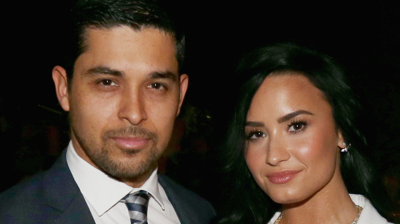 Wilmer Valderrama and Demi Lovato pose together at an event