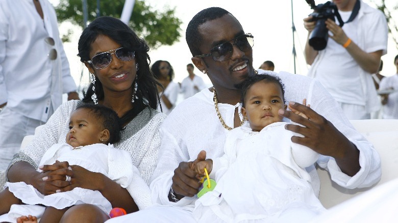 Kim Porter and Diddy holding their twins